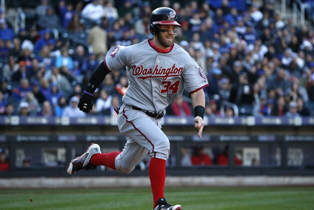 Washington Nationals Bryce Harper, trying for the National League batting title, runs out a ground ball in the seventh inning of a baseball game in New York, Sunday, Oct. 4, 2015. (AP Photo/Kathy Willens)