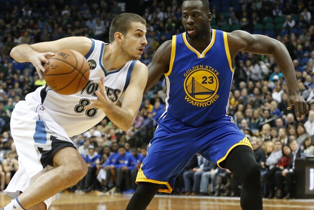 Minnesota Timberwolves’ Nemanja Bjelica, left, drives around Golden State Warriors' Draymond Green during the first quarter of an NBA basketball game, Thursday, Nov. 12, 2015, in Minneapolis. (AP Photo/Jim Mone)
