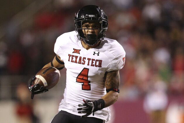 Sep 19, 2015; Fayetteville, AR, USA; Texas Tech Red Raiders running back Justin Stockton (4) rushes in the fourth quarter against the Arkansas Razorbacks at Donald W. Reynolds Razorback Stadium. Texas Tech defeated Arkansas 35-24. Mandatory Credit: Nelson Chenault-USA TODAY Sports