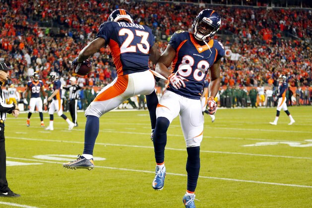 Denver Broncos running back Ronnie Hillman (23) celebrates his touchdown with Demaryius Thomas (88) during the first half of an NFL football game against the Green Bay Packers, Sunday, Nov. 1, 2015, in Denver. (AP Photo/Jack Dempsey)