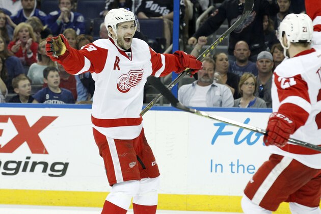 Apr 25, 2015; Tampa, FL, USA; Detroit Red Wings center Pavel Datsyuk (13) is congratulated after he scored  goal against the Tampa Bay Lightning during the third period in game five of the first round of the 2015 Stanley Cup Playoffs at Amalie Arena. Detroit Red Wings defeated the Tampa Bay Lightning 4-0.  Mandatory Credit: Kim Klement-USA TODAY Sports