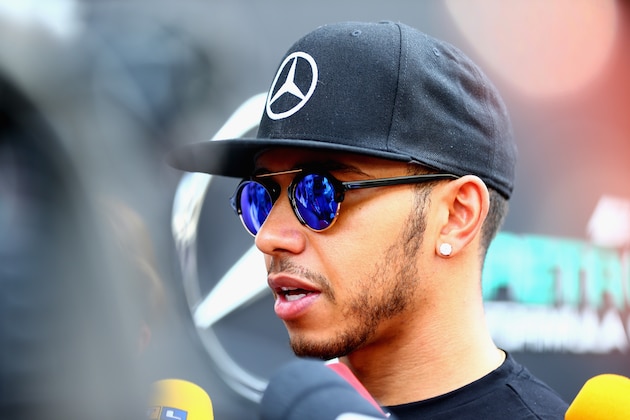 SAO PAULO, BRAZIL - NOVEMBER 12:  Lewis Hamilton of Great Britain and Mercedes GP speaks with members of the media in the paddock during previews for the Formula One Grand Prix of Brazil at Autodromo Jose Carlos Pace on November 12, 2015 in Sao Paulo, Brazil.  (Photo by Clive Mason/Getty Images)