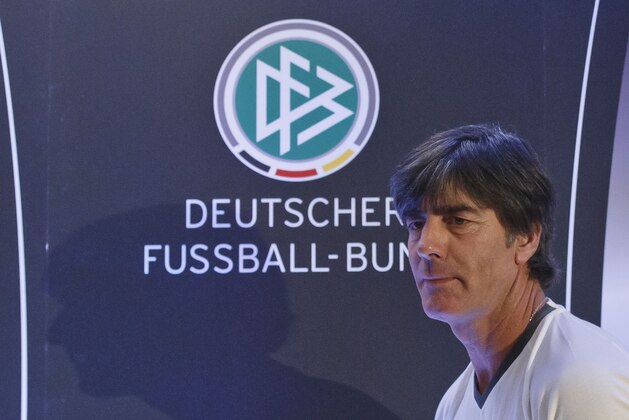 Germany's head coach Joachim Loew arrives for a news conference in Paris, France, Thursday, Nov. 12, 2015. Germany will face France in a friendly soccer match on Friday. The logo of the German soccer association in the background. (AP Photo/Michel Euler)