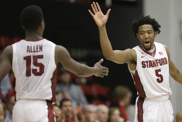 Stanford's Marcus Allen (15) and Chasson Randle (5) celebrates during the second half of an NCAA college basketball game in the National Invitation Tournament against Vanderbilt in Stanford, Calif., Tuesday, March 24, 2015. Stanford won 78-75. (AP Photo/Jeff Chiu)