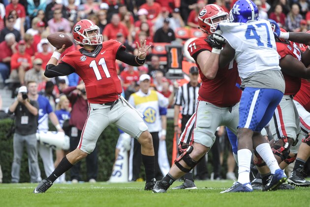 Georgia quarterback Greyson Lambert (11) passes under protection from Georgia offensive tackle John Theus (71) as Kentucky defensive end Jabari Johnson (47) defends during the second half of an NCAA college football game, Saturday, Nov. 7, 2015, in Athens, Ga. Georgia won 27-3. (AP Photo/John Amis)