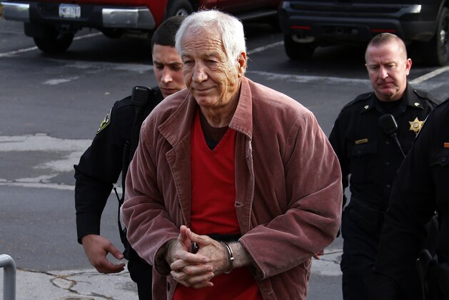 Former Penn State University assistant football coach Jerry Sandusky, center, arrives at the Centre County Courthouse for a hearing about his appeal in Bellefonte, Pa. Thursday, Oct. 29, 2015. (AP Photo/Gene J. Puskar)