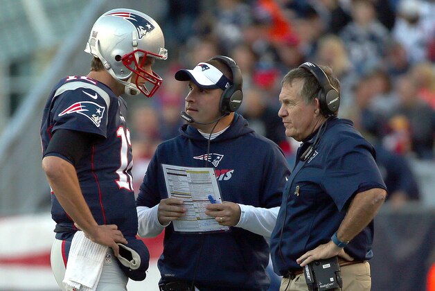 FOXBORO, MA - NOVEMBER 8: Tom Brady #12 of the New England Patriots confers with Josh McDaniels and Bill Belichick in the second half during a game with the Washington Redskins at Gillette Stadium on November 8, 2015 in Foxboro, Massachusetts. (Photo by Jim Rogash/Getty Images)