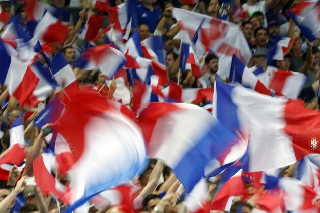 France's fans wave French flags during the France vs England rugby friendly match at Stade de France in Saint Denis, north of Paris, France, Saturday Aug. 22, 2015. France is playing England in a series of friendly rugby internationals being held in advance of the upcoming Rugby World Cup that starts in September. (AP Photo/Francois Mori)