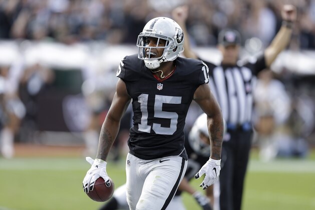 Oakland Raiders wide receiver Michael Crabtree (15) reacts after catching a touchdown pass during the first half of an NFL football game against the New York Jets in Oakland, Calif., Sunday, Nov. 1, 2015. (AP Photo/Ben Margot)