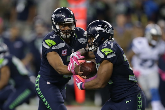 Seattle Seahawks quarterback Russell Wilson, left, hands off to running back Thomas Rawls in the second half of an NFL football game against the Detroit Lions, Monday, Oct. 5, 2015, in Seattle. (AP Photo/Scott Eklund)