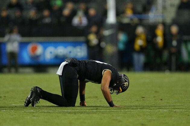 BOULDER, CO - NOVEMBER 13:  Quarterback Sefo Liufau #13 of the Colorado Buffaloes goes down with a foot injury against the USC Trojans at Folsom Field on November 13, 2015 in Boulder, Colorado. (Photo by Justin Edmonds/Getty Images)