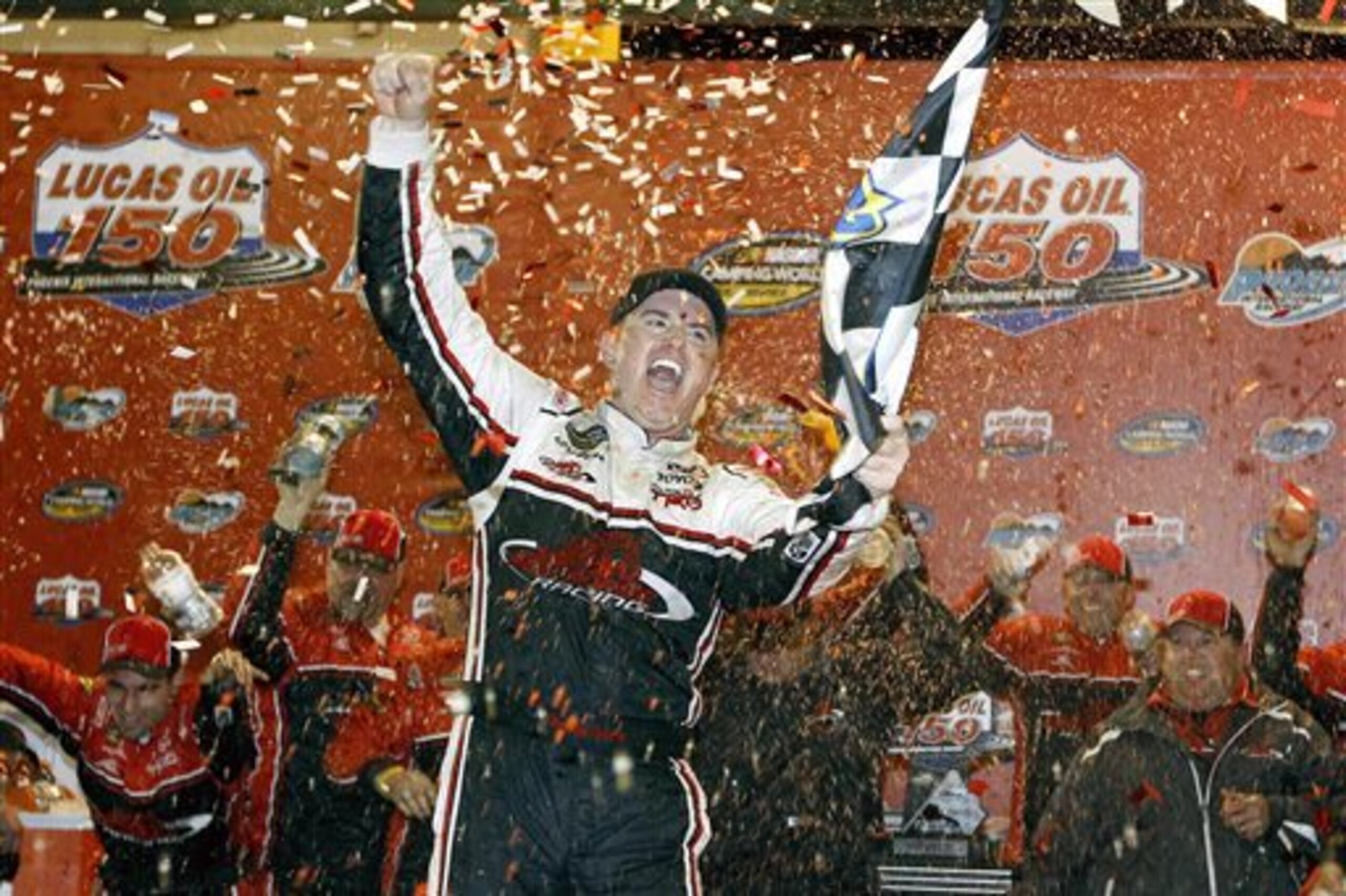 Timothy Peters celebrates in Victory Lane after winning the NASCAR Trucks auto race at Phoenix International Raceway, Friday, Nov. 13, 2015, in Avondale, Ariz. (AP Photo/Ralph Freso)