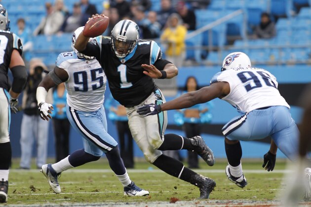 Carolina Panthers' Cam Newton (1) scrambles as Tennessee Titans' Malcolm Sheppard (96) and  William Hayes (95) pursue during the fourth quarter of the Titans' 30-3 win in an NFL football game in Charlotte, N.C., Sunday, Nov. 13, 2011. (AP Photo/Bob Leverone)