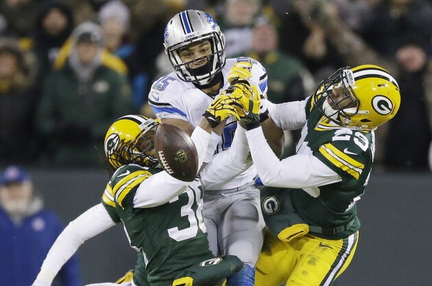 Green Bay Packers' Tramon Williams (38) and Casey Hayward break up a pass intended for Detroit Lions' Golden Tate during the second half of an NFL football game Sunday, Dec. 28, 2014, in Green Bay, Wis. The Packers won 30-20. (AP Photo/Tom Lynn)