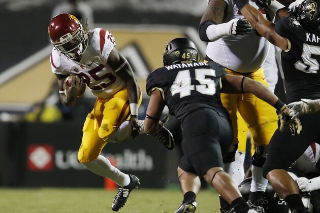 Southern California running back Ronald Jones II, left, is stopped by Colorado linebacker Grant Watanabe during the first half of an NCAA college football game Friday, Nov. 13, 2015, in Boulder, Colo. (AP Photo/David Zalubowski)