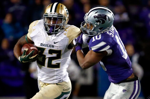 MANHATTAN, KS - NOVEMBER 05:  Running back Shock Linwood #32 of the Baylor Bears carries the ball as defensive back Donnie Starks #10 of the Kansas State Wildcats defends during the game at Bill Snyder Family Football Stadium on November 5, 2015 in Manhattan, Kansas.  (Photo by Jamie Squire/Getty Images)