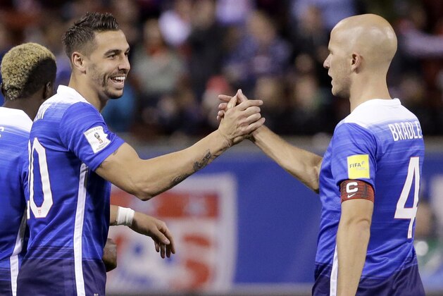 United States’ Geoff Cameron, left, is congratulated by teammate Michael Bradley after scoring during the second half of a 2018 World Cup qualifying soccer match against St. Vincent and the Grenadines Friday, Nov. 13, 2015, in St. Louis. The United States won 6-1. (AP Photo/Jeff Roberson)