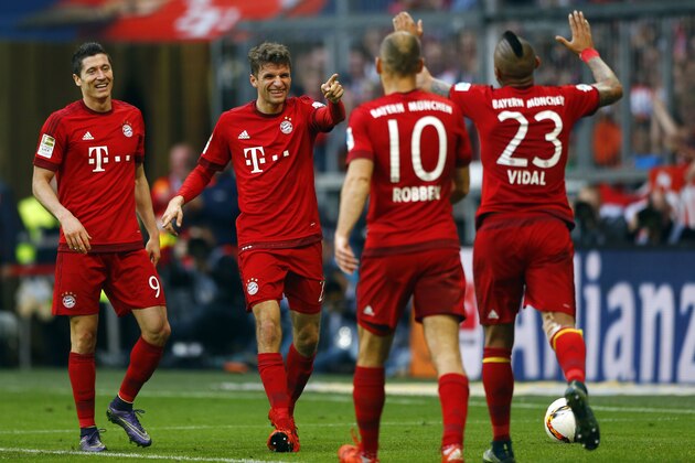 Bayern's Thomas Mueller, second left,  celebrates after scoring his side's fourth goal during the German Bundesliga soccer match between FC Bayern Munich and VfB Stuttgart in Munich, Germany, Saturday, Nov. 7, 2015. (AP Photo/Matthias Schrader)