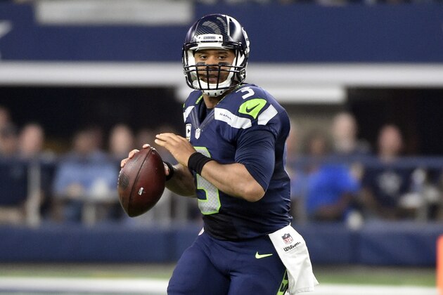 Seattle Seahawks' Russell Wilson (3) prepares to throw as he rolls out of the pocket in the first half of an NFL football game against the Dallas Cowboys, Sunday, Nov. 1, 2015, in Arlington, Texas. (AP Photo/Michael Ainsworth)