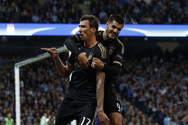 Juventus' Mario Mandzukic, left, celebrates with Alvaro Morata  after scoring a goal during the Champions League group D soccer match between Manchester City and Juventus at the Etihad Stadium, Manchester, England, Tuesday, Sept. 15, 2015. (AP Photo/Jon Super)