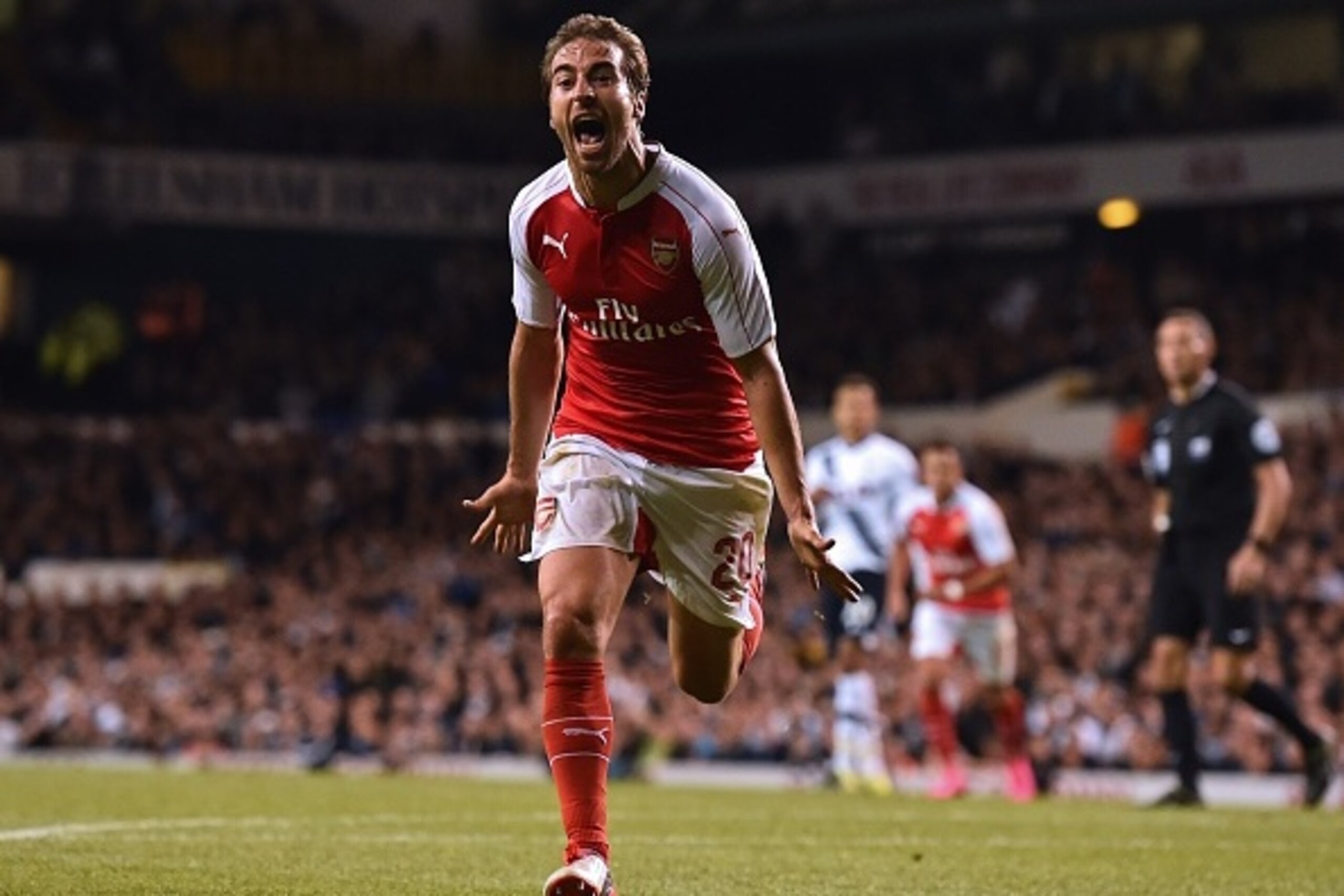 Arsenal's French midfielder Mathieu Flamini celebrates after scoring their seond goal during the English League Cup third round football match between Tottenham Hotspur and Arsenal at White Hart Lane in north London on September 23, 2015. AFP PHOTO / BEN STANSALL

RESTRICTED TO EDITORIAL USE. No use with unauthorized audio, video, data, fixture lists, club/league logos or 'live' services. Online in-match use limited to 75 images, no video emulation. No use in betting, games or single club/league/player publications.        (Photo credit should read BEN STANSALL/AFP/Getty Images)