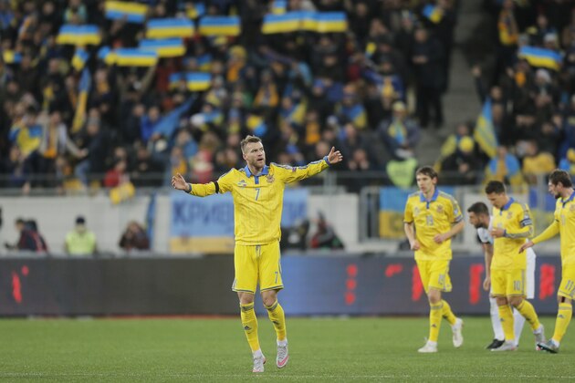 Ukraine's Andriy Yarmolenko, center, gestures after scoring the first goal during the Euro 2016 play-off first leg soccer match between Ukraine and Slovenia, in Lviv, Ukraine, Saturday, Nov. 14, 2015. (AP Photo/Efrem Lukatsky)