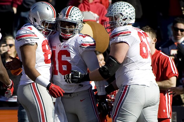 Nov 14, 2015; Champaign, IL, USA; Ohio State Buckeyes quarterback J.T. Barrett (16) celebrates a touchdown with tight end Marcus Baugh (85), and offensive lineman Pat Elflein (65) in the game against the Illinois Fighting Illini at Memorial Stadium. Mandatory Credit: Mike Granse-USA TODAY Sports