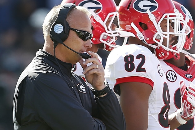 Georgia head coach Mark Richt listens in as coaches talk to players in a timeout during the second quarter of an NCAA football game, Saturday against Auburn, Nov. 14, 2015, in Auburn, Ala. (AP Photo/Butch Dill)