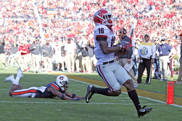 Georgia wide receiver Isaiah McKenzie (16) gets around Auburn defensive back Jonathan Jones (3) and carries the ball in for a touchdown during the second half of an NCAA football game, Saturday, Nov. 14, 2015, in Auburn, Ala. Georgia won 20-13. (AP Photo/Butch Dill)