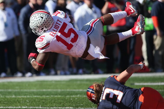 CHAMPAIGN, IL - NOVEMBER 14:  Ezekiel Elliott #15 of the Ohio State Buckeyes is tripped up by Taylor Barton #3 of the Illinois Fighting Illini at Memorial Stadium on November 14, 2015 in Champaign, Illinois.  (Photo by Jonathan Daniel/Getty Images)