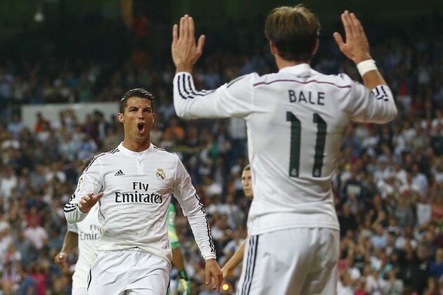 Real's Cristiano Ronaldo, left, celebrates his goal with Gareth Bale, right, during a Spanish La Liga soccer match between Real Madrid and Athletic Bilbao at the Santiago Bernabeu stadium in Madrid, Spain, Sunday, Oct. 5, 2014. (AP Photo/Andres Kudacki)