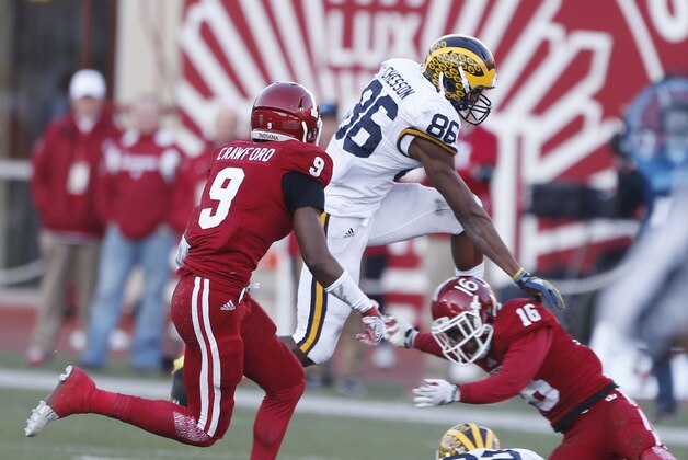Nov 14, 2015; Bloomington, IN, USA; Michigan Wolverines wide receiver Jehu Chesson (86) is tackled by Indiana Hoosiers cornerback Rashard Fant (16) at Memorial Stadium. Mandatory Credit: Brian Spurlock-USA TODAY Sports