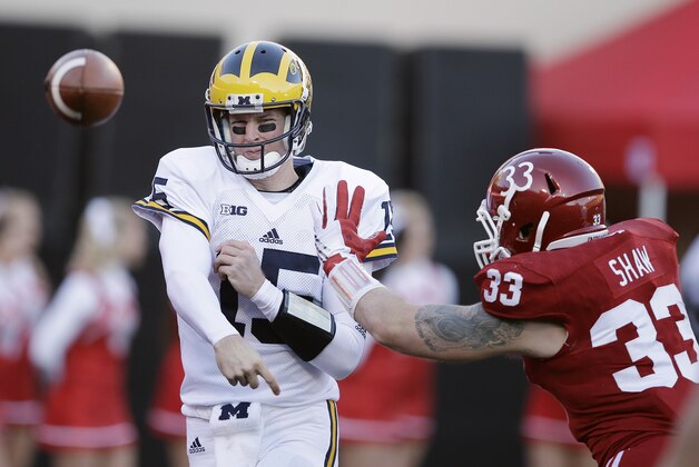 Michigan's Jake Rudock (15) throws while being pressured by Indiana's Zack Shaw (33) during the first half of an NCAA college football game Saturday, Nov. 14, 2015, in Bloomington, Ind. (AP Photo/Darron Cummings)
