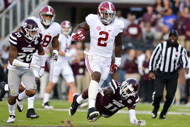 Nov 14, 2015; Starkville, MS, USA; Alabama Crimson Tide running back Derrick Henry (2) avoids a tackle by Mississippi State Bulldogs defensive back Kivon Coman (11) during a run that would result in a touchdown during the second quarter at Davis Wade Stadium. Mandatory Credit: Matt Bush-USA TODAY Sports