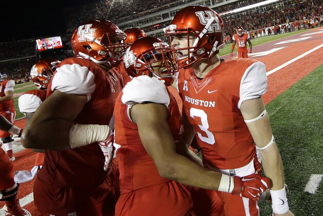 Houston quarterback Kyle Postma (3) celebrates with Chance Allen, center, and teammates after scoring a touchdown during the fourth quarter of an NCAA college football game against Memphis, Saturday, Nov. 14, 2015, in Houston. (AP Photo/David J. Phillip)