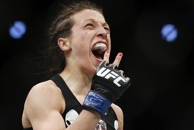 Joanna Jedrzejczyk, of Poland, celebrates defeating Carla Esparza in a women's strawweight UFC 185 mixed martial arts title bout, Saturday, March 14, 2015, in Dallas. Jedrzejczyk won by TKO in two rounds. (AP Photo/Brandon Wade)