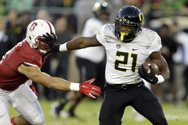 Oregon's Royce Freeman, right, straight arms Stanford's Blake Martinez during the first half of an NCAA college football game Saturday, Nov. 14, 2015, in Stanford, Calif. (AP Photo/Ben Margot)