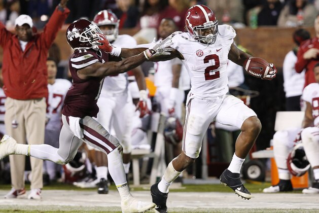 Alabama running back Derrick Henry (2) fights offs an attempted tackle by Mississippi State defensive back Kivon Coman (11) on his way to a 65-yard touchdown during the second half of an NCAA college football game in Starkville, Miss., Saturday, Nov. 14, 2015. No. 3 Alabama won 31-6. (AP Photo/Rogelio V. Solis)