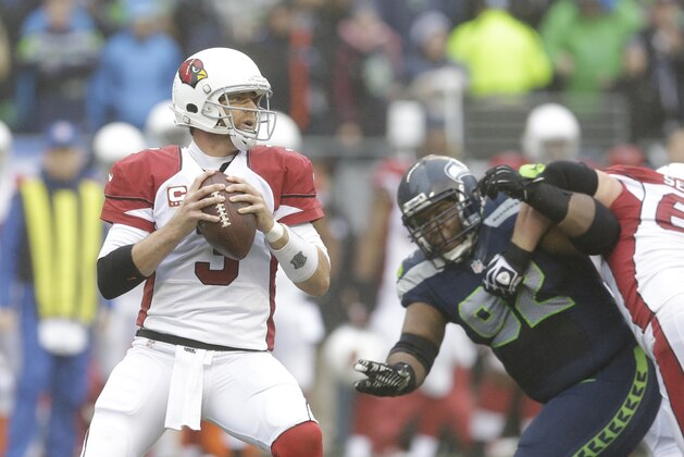 Arizona Cardinals quarterback Carson Palmer (3) looks to pass against the Seattle Seahawks in the first half of an NFL football game, Sunday, Dec. 22, 2013, in Seattle. (AP Photo/Elaine Thompson)