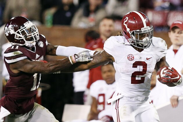 Alabama running back Derrick Henry (2) fights offs an attempted tackle by Mississippi State defensive back Kivon Coman (11) on his way to a 65-yard touchdown during the second half of an NCAA college football game in Starkville, Miss., Saturday, Nov. 14, 2015. No. 3 Alabama won 31-6. (AP Photo/Rogelio V. Solis)