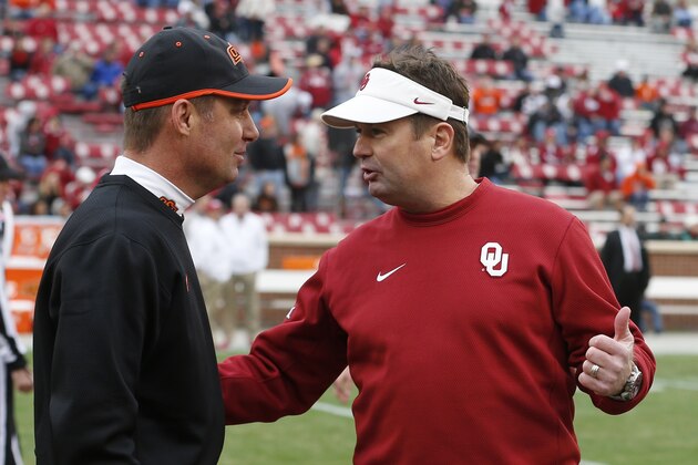 Oklahoma State head coach Mike Gundy, left, talks with Oklahoma head coach Bob Stoops, right, before the start of an NCAA college football game in Norman, Okla., Saturday, Dec. 6, 2014. (AP Photo/Sue Ogrocki) Oklahoma State head coach Mike Gundy, left, talks with Oklahoma head coach Bob Stoops, right, before the start of an NCAA college football game in Norman, Okla., Saturday, Dec. 6, 2014. (AP Photo/Sue Ogrocki)