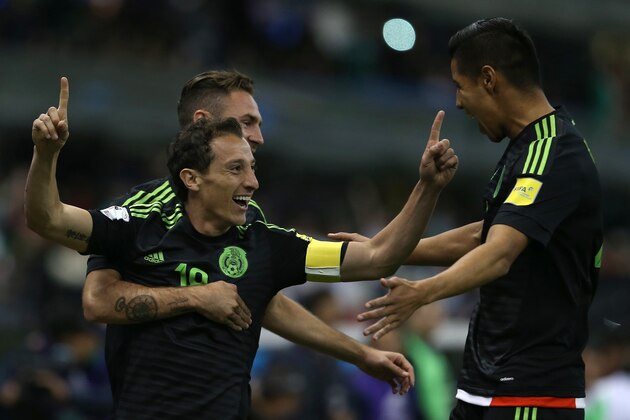 Mexico's Andres Guardado, right,  celebrates after scoring against El Salvador with teammates Miguel Layun, back, and Hugo Ayala, during a 2018 World Cup qualifying soccer match in Mexico City, Friday, Nov. 13, 2015. (AP Photo/Christian Palma)
