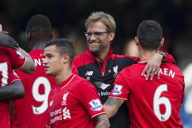 Liverpool's head coach Juergen Klopp, second right, celebrates with his players including goal scorers Philippe Coutinho, third right, and Christian Benteke, 9, on the pitch after the English Premier League soccer match between Chelsea and Liverpool at Stamford Bridge stadium in London, Saturday, Oct. 31, 2015. Liverpool won 3-1. (AP Photo/Matt Dunham) Liverpool's head coach Juergen Klopp, second right, celebrates with his players including goal scorers Philippe Coutinho, third right, and Christian Benteke, 9, on the pitch after the English Premier League soccer match between Chelsea and Liverpool at Stamford Bridge stadium in London, Saturday, Oct. 31, 2015. Liverpool won 3-1. (AP Photo/Matt Dunham)