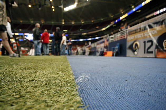 New surface area is seen next to the turf field inside the Edward Jones Dome before the start of an NFL football game between the St. Louis Rams and the Chicago Bears Sunday, Nov. 15, 2015, in St. Louis. The surface has been added after San Francisco 49ers Reggie Bush slipped and fell injuring himself on the uncovered, smooth surface underneath during a recent game. (AP Photo/Tom Gannam)