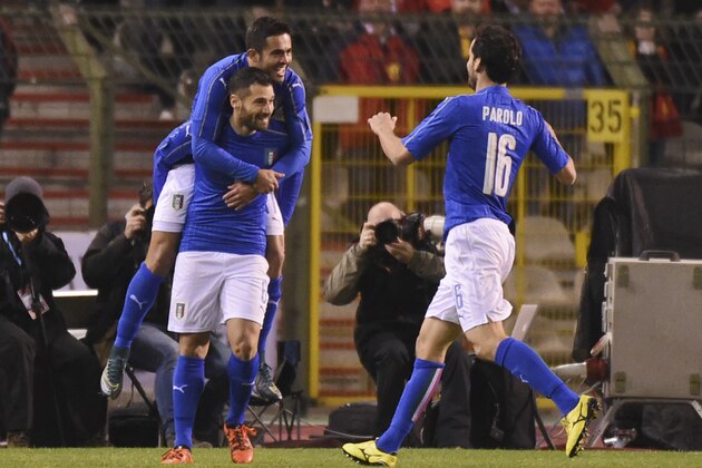 Italy's Italy’s Antonio Candreva, celebrates with his teammates Eder, above, and Marco Parolo, right, after scoring the opening goal during a friendly soccer match between Belgium and Italy at the King Baudouin stadium in Brussels on Friday, Nov. 13, 2015. (AP Photo/Geert Vanden Wijngaert)