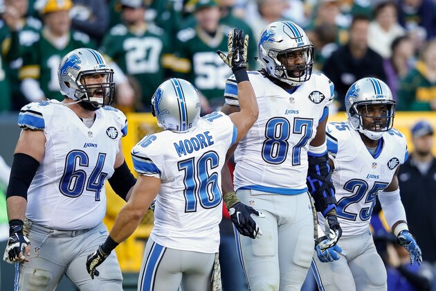 GREEN BAY, WI - NOVEMBER 15:  Brandon Pettigrew #87 of the Detroit Lions reacts with teammates  Travis Swanson #64,  Lance Moore #16 and  Theo Riddick #25 after scoring a touchdown in the third quarter against the Green Bay Packers at Lambeau Field on November 15, 2015 in Green Bay, Wisconsin.  (Photo by Joe Robbins/Getty Images)