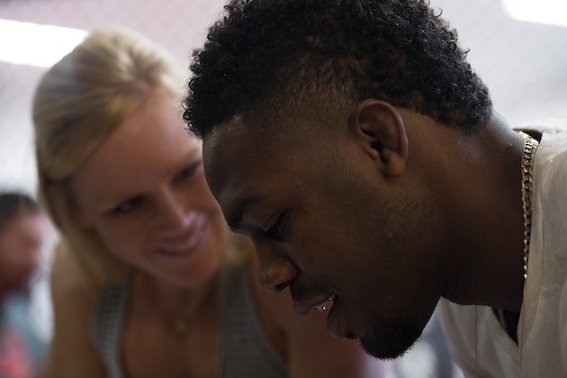 ALBUQUERQUE, NM - OCTOBER 31:  (L-R) Holly Holm and Jon Jones sign autographs for fans during the Jackson Wink MMA Academy Grand Opening at Jackson's Mixed Martial Arts & Fitness on October 31, 2015 in Albuquerque, New Mexico. (Photo by Brandon Magnus/Zuffa LLC/Zuffa LLC via Getty Images)
