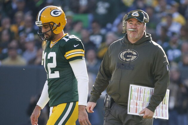 Green Bay Packers head coach Mike McCarthy talks to quarterback Aaron Rodgers during the first half of an NFL football game against the Detroit Lions Sunday, Nov. 15, 2015, in Green Bay, Wis. (AP Photo/Mike Roemer)