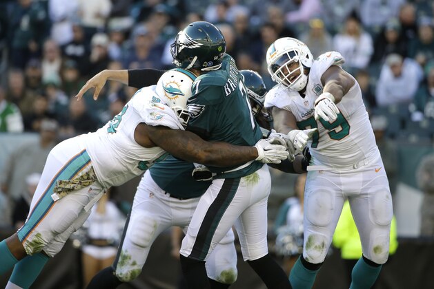 Philadelphia Eagles' Sam Bradford is hit by Miami Dolphins' C.J. Mosley during the first half of an NFL football game, Sunday, Nov. 15, 2015, in Philadelphia. (AP Photo/Matt Rourke)