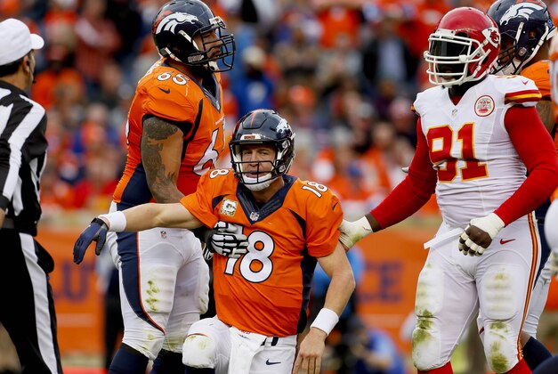Denver Broncos quarterback Peyton Manning (18) is helped up to his feet by teammate Louis Vasquez (65) and Kansas City Chiefs outside linebacker Tamba Hali (91)after a sack during the first half of an NFL football game, Sunday, Nov. 15, 2015, in Denver. (AP Photo/Joe Mahoney)